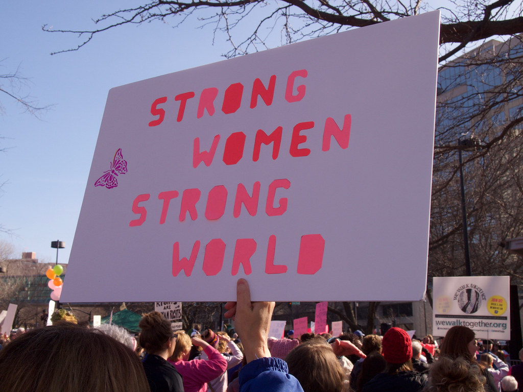 A sign reads Strong Women Strong World