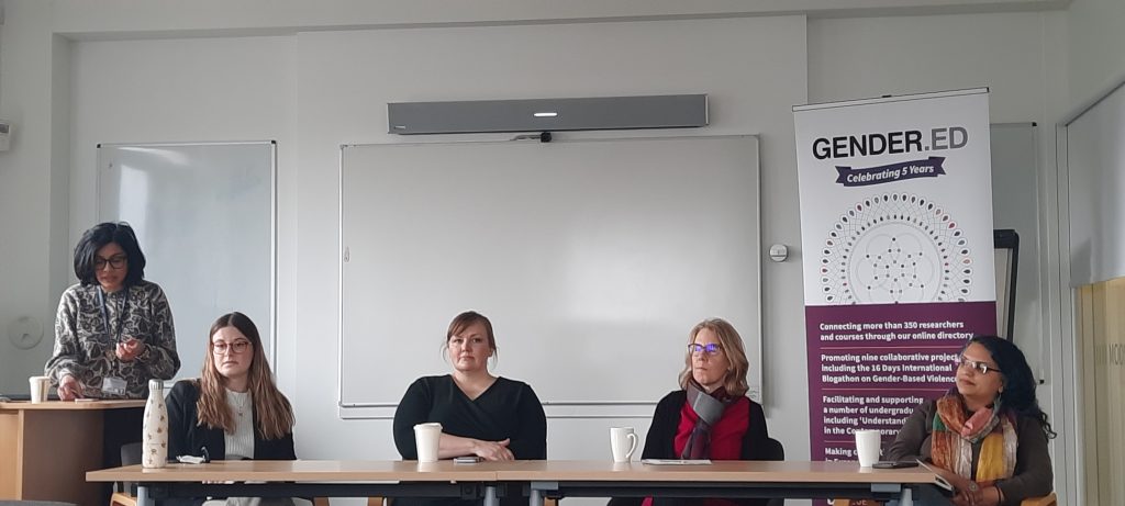 five panelists in front of a GENDER.ED pop-upsign