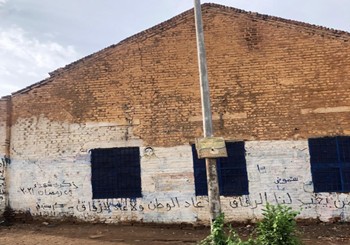 Photo of a building in Khartoum, Sudan with graffiti in Arabic that reads 'Who is going to bring our fellows back. Neither fellows nor country have come back. In remembrance of the martyrs of 29th Ramadan 2021'