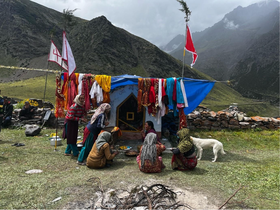 A group of people outside a tent

Description automatically generated