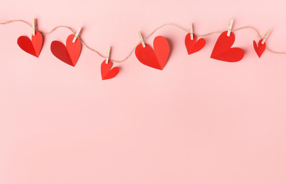 Image of small paper hearts attached to a string with clips.